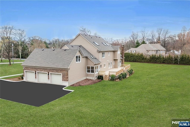 333 Mill Rd, Saddle River, NJ 07458 - view of side of home with a garage, a deck, a yard, and asphalt driveway