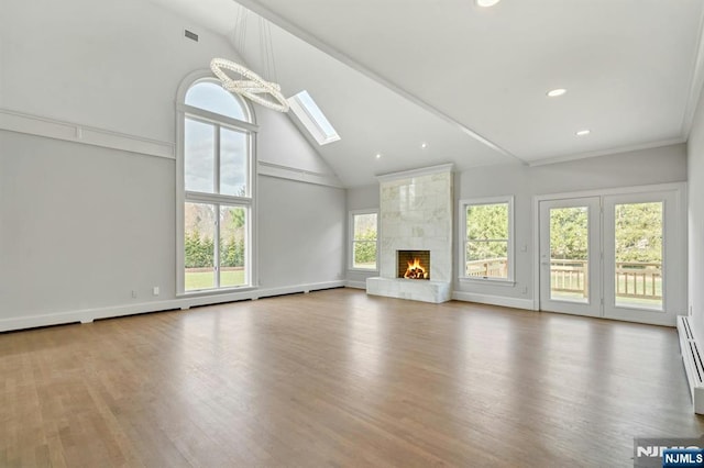 333 Mill Rd, Saddle River, NJ 07458 - unfurnished living room with high vaulted ceiling, a skylight, wood finished floors, recessed lighting, and a high end fireplace