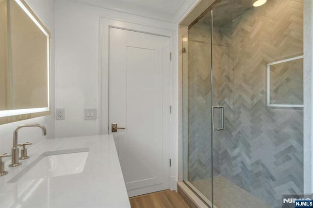 333 Mill Rd, Saddle River, NJ 07458 - bathroom with a stall shower, vanity, and wood finished floors