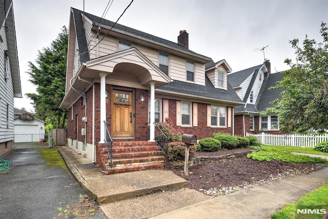 123 Buena Vista Ave, Hawthorne, NJ 07506 - view of front of home with brick siding, an outbuilding, a garage, and a chimney