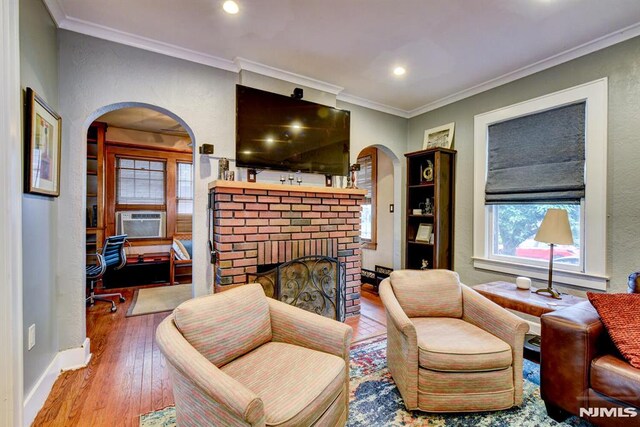 123 Buena Vista Ave, Hawthorne, NJ 07506 - living area with arched walkways, a fireplace, crown molding, hardwood / wood-style floors, and cooling unit
