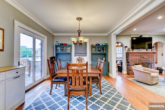 123 Buena Vista Ave, Hawthorne, NJ 07506 - dining area featuring light wood finished floors, a chandelier, a brick fireplace, crown molding, and recessed lighting