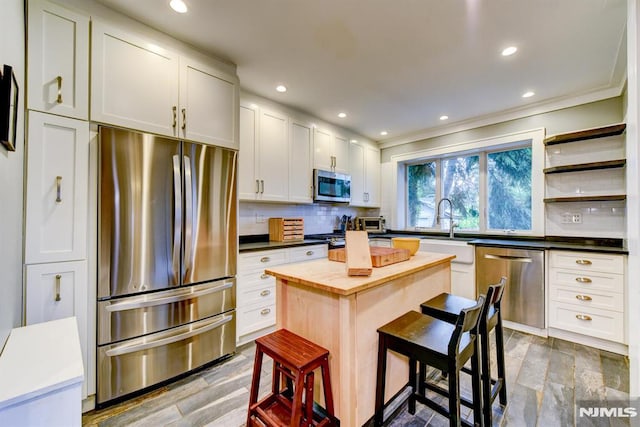 123 Buena Vista Ave, Hawthorne, NJ 07506 - kitchen featuring appliances with stainless steel finishes, wood counters, decorative backsplash, recessed lighting, and a breakfast bar