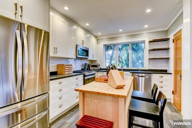 123 Buena Vista Ave, Hawthorne, NJ 07506 - kitchen featuring stainless steel appliances, butcher block countertops, white cabinets, decorative backsplash, and ornamental molding