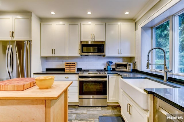 123 Buena Vista Ave, Hawthorne, NJ 07506 - kitchen featuring appliances with stainless steel finishes, wooden counters, decorative backsplash, white cabinetry, and recessed lighting