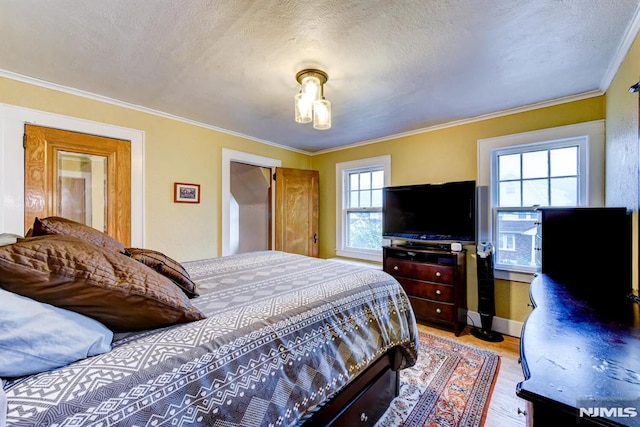 123 Buena Vista Ave, Hawthorne, NJ 07506 - bedroom with light wood-style flooring, crown molding, and a textured ceiling