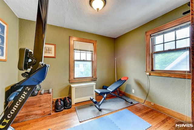 123 Buena Vista Ave, Hawthorne, NJ 07506 - workout room with wood finished floors, healthy amount of natural light, radiator, a textured ceiling, and a textured wall