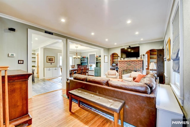 123 Buena Vista Ave, Hawthorne, NJ 07506 - living area with crown molding, light wood-style floors, a chandelier, recessed lighting, and a fireplace
