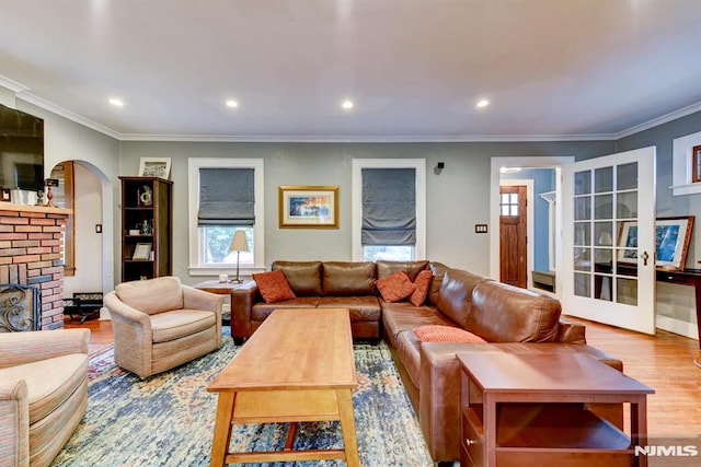 123 Buena Vista Ave, Hawthorne, NJ 07506 - living room with wood finished floors, arched walkways, crown molding, a brick fireplace, and recessed lighting