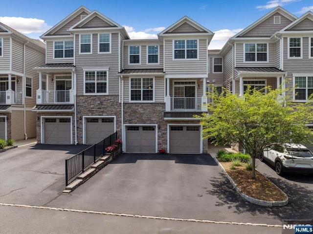 73 Autumn Way Unit 24, Montvale, NJ 07645 - townhome / multi-family property featuring driveway, a garage, stone siding, and a standing seam roof