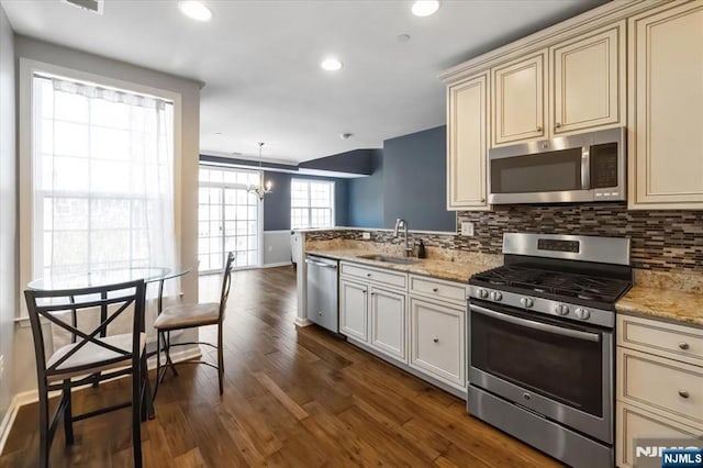 73 Autumn Way Unit 24, Montvale, NJ 07645 - kitchen featuring stainless steel appliances, cream cabinets, backsplash, dark wood finished floors, and recessed lighting