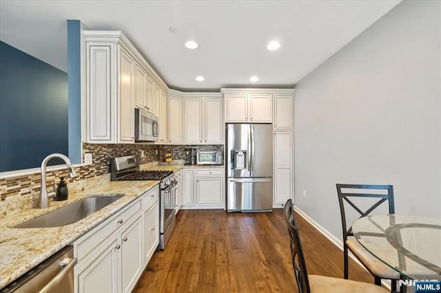 73 Autumn Way Unit 24, Montvale, NJ 07645 - kitchen with appliances with stainless steel finishes, backsplash, recessed lighting, dark wood-style flooring, and light stone countertops