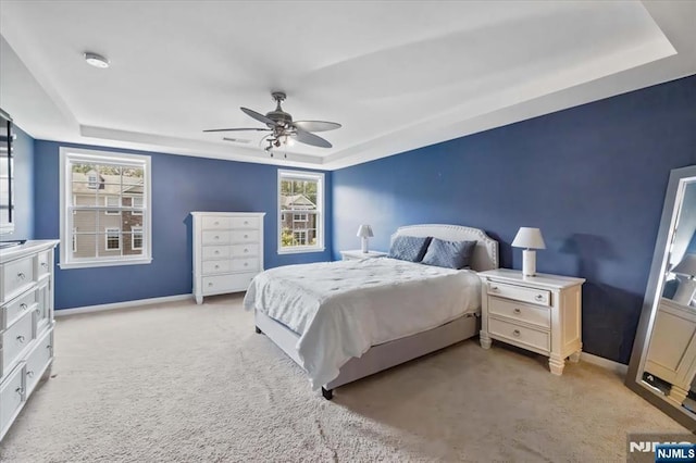 73 Autumn Way Unit 24, Montvale, NJ 07645 - bedroom featuring a tray ceiling, light colored carpet, ceiling fan, and multiple windows