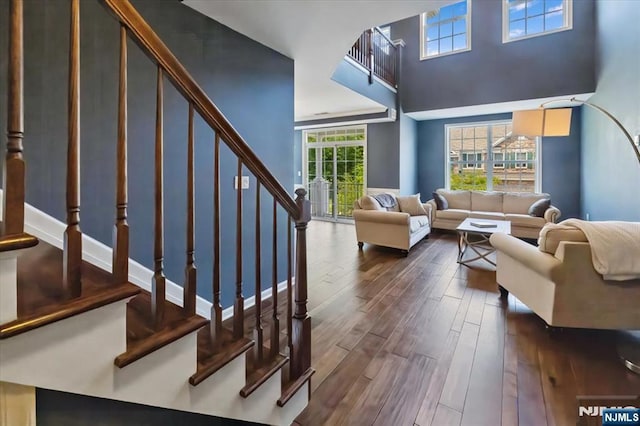 73 Autumn Way Unit 24, Montvale, NJ 07645 - living room with dark wood-style floors, stairway, and a high ceiling