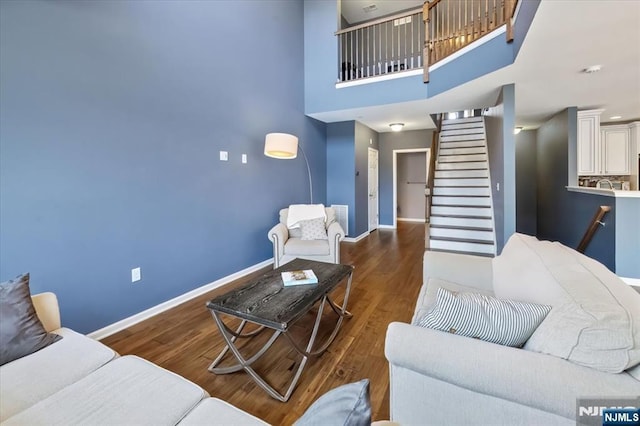 73 Autumn Way Unit 24, Montvale, NJ 07645 - living area featuring wood finished floors, stairway, and a towering ceiling