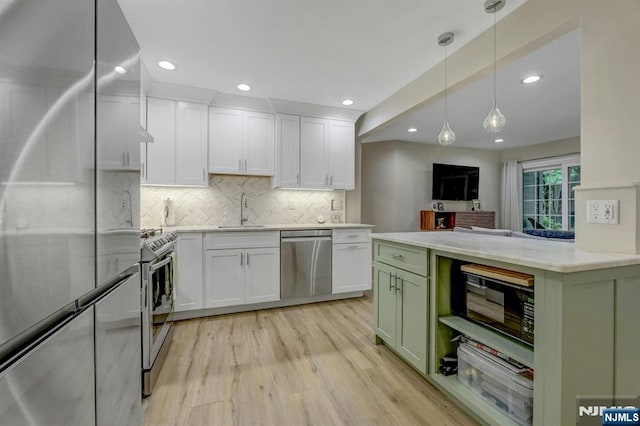 669 Juniper Way, Mahwah, NJ 07430 - kitchen featuring stainless steel appliances, light wood-style floors, white cabinetry, green cabinetry, and decorative backsplash