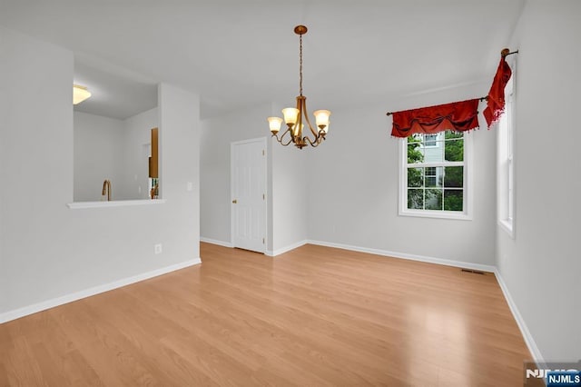 231 Swathmore Dr, Nutley, NJ 07110 - spare room featuring light wood-type flooring and a chandelier