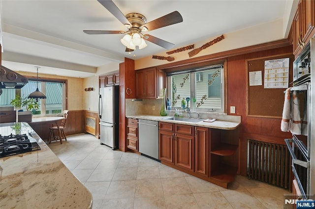 405 Abbott Ave, Ridgefield, NJ 07657 - kitchen featuring black appliances, wood walls, a ceiling fan, light stone counters, and decorative light fixtures