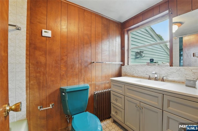 405 Abbott Ave, Ridgefield, NJ 07657 - full bath featuring radiator heating unit, vanity, a tub to relax in, and wood walls
