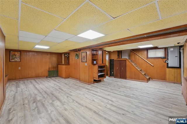 405 Abbott Ave, Ridgefield, NJ 07657 - finished below grade area with radiator, a drop ceiling, light wood finished floors, electric panel, and stairs