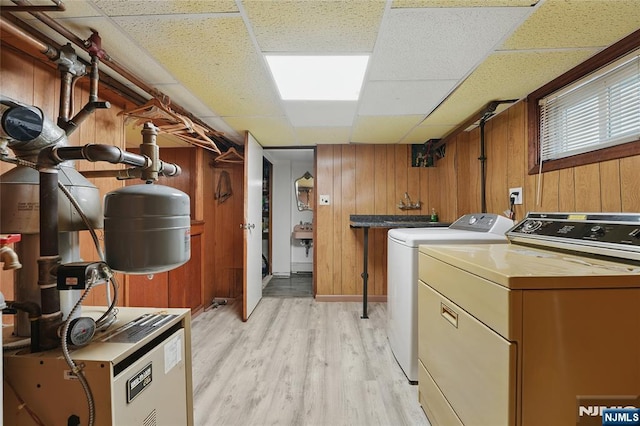 405 Abbott Ave, Ridgefield, NJ 07657 - laundry room featuring light wood finished floors, independent washer and dryer, wood walls, and a heating unit