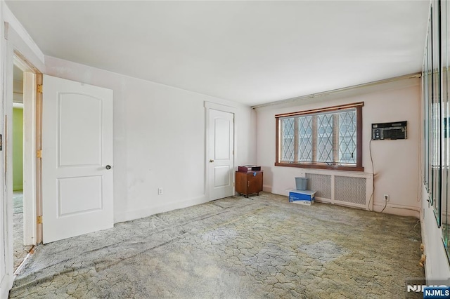 405 Abbott Ave, Ridgefield, NJ 07657 - carpeted empty room with radiator heating unit and a wall unit AC