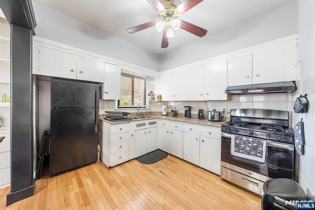 178-180 17th Ave, Paterson, NJ 07504 - kitchen featuring freestanding refrigerator, gas range, under cabinet range hood, and white cabinets