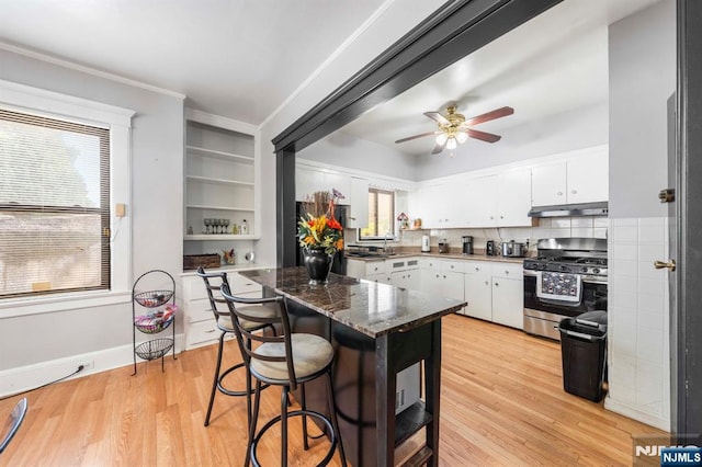 178-180 17th Ave, Paterson, NJ 07504 - kitchen featuring gas range, white cabinetry, light wood finished floors, ceiling fan, and ornamental molding