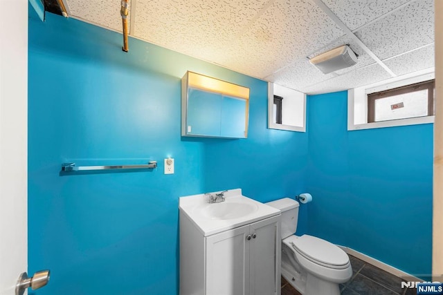 178-180 17th Ave, Paterson, NJ 07504 - half bath featuring vanity, a drop ceiling, and tile patterned flooring