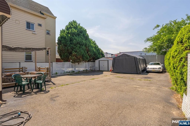 178-180 17th Ave, Paterson, NJ 07504 - view of yard featuring a storage unit and a patio