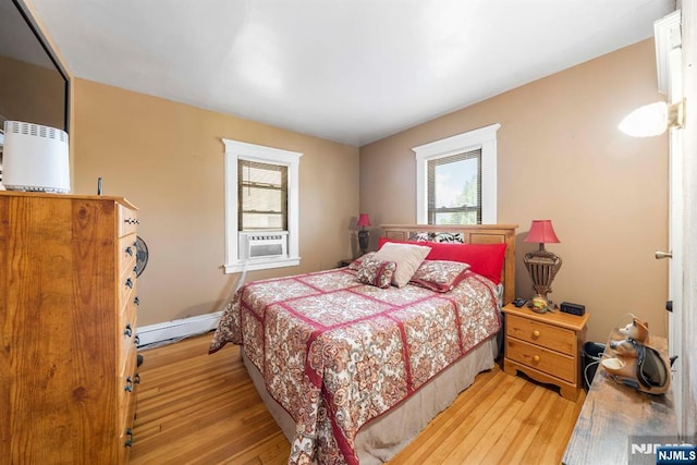 178-180 17th Ave, Paterson, NJ 07504 - bedroom featuring multiple windows, light wood-style floors, a baseboard heating unit, and cooling unit