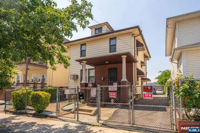 178-180 17th Ave, Paterson, NJ 07504 - traditional style home with a gate, a fenced front yard, and brick siding