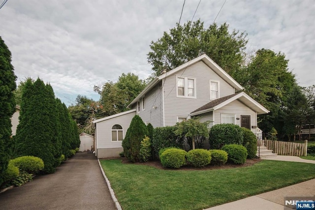 695 Asbury St, New Milford, NJ 07646 - view of front of house featuring a front lawn and an outdoor structure