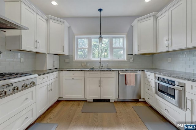 178 Arthur St, Hillsdale, NJ 07642 - kitchen featuring stainless steel appliances, wall chimney exhaust hood, recessed lighting, white cabinetry, and backsplash