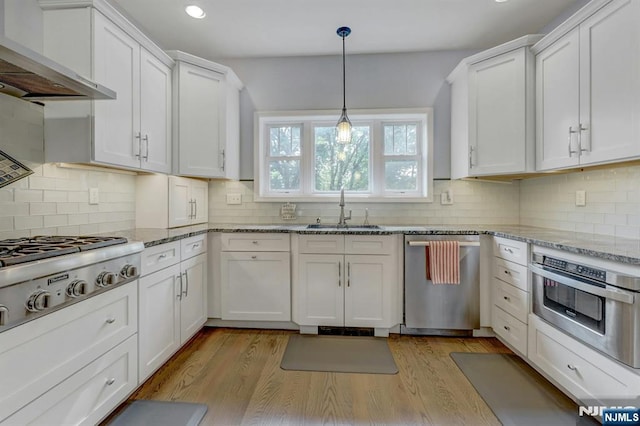 178 Arthur St, Hillsdale, NJ 07642 - kitchen with stainless steel appliances, wall chimney range hood, white cabinets, backsplash, and recessed lighting