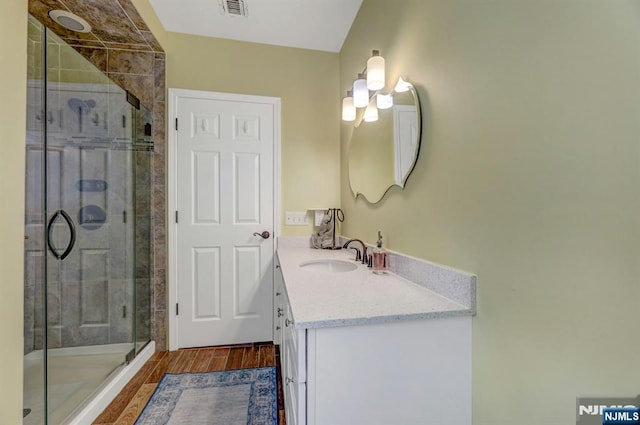 178 Arthur St, Hillsdale, NJ 07642 - bathroom with vanity, a shower stall, and wood finished floors
