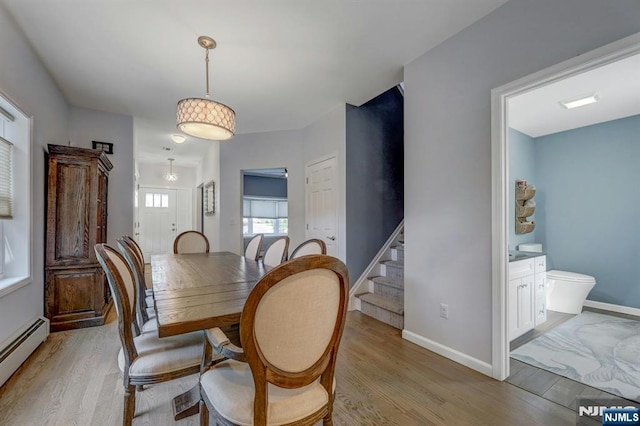 178 Arthur St, Hillsdale, NJ 07642 - dining room with baseboard heating, light wood-style floors, and stairs