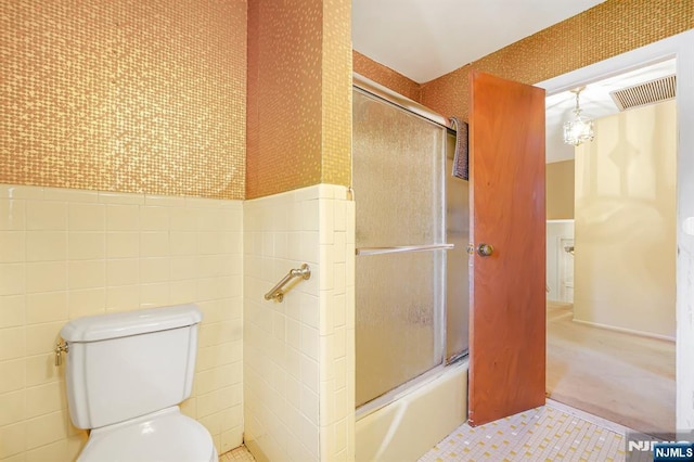 24 Eton Ct, Wayne, NJ 07470 - bathroom featuring a wainscoted wall, bath / shower combo with glass door, and tile walls
