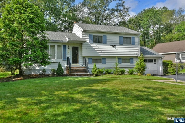 29 Lotus Ln, Waldwick, NJ 07463 - split level home featuring a front lawn, a garage, a shingled roof, and driveway