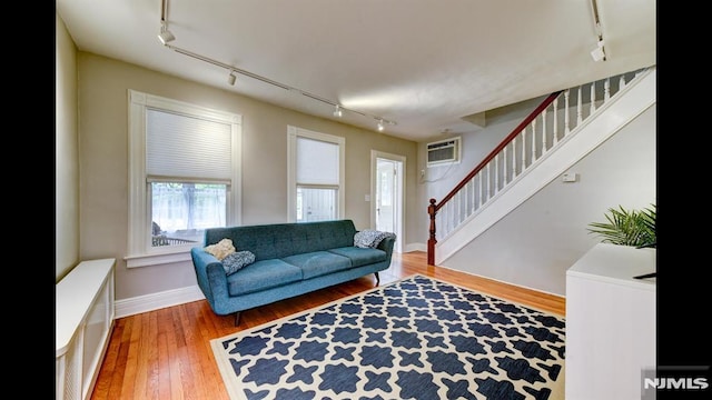 118 High St, Nutley, NJ 07110 - living room with track lighting, a wall mounted air conditioner, stairway, and wood finished floors