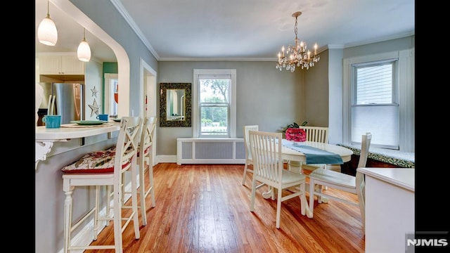 118 High St, Nutley, NJ 07110 - dining room featuring radiator, plenty of natural light, light wood-type flooring, a chandelier, and crown molding