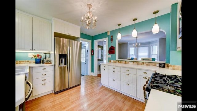 118 High St, Nutley, NJ 07110 - kitchen featuring stainless steel fridge with ice dispenser, a chandelier, gas range oven, light countertops, and light wood-type flooring