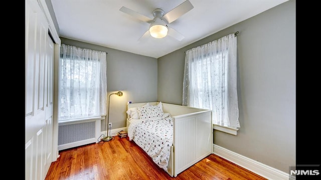 118 High St, Nutley, NJ 07110 - bedroom with radiator, wood finished floors, and a ceiling fan