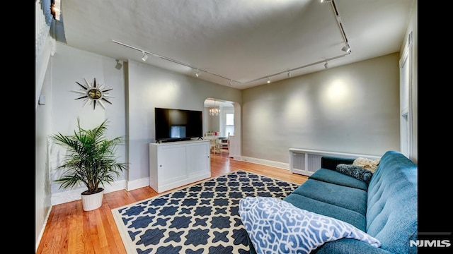 118 High St, Nutley, NJ 07110 - living area with rail lighting, arched walkways, wood finished floors, and radiator