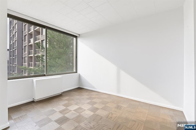 9060 Palisade Ave Unit 511, North Bergen, NJ 07047 - empty room with radiator heating unit and baseboards