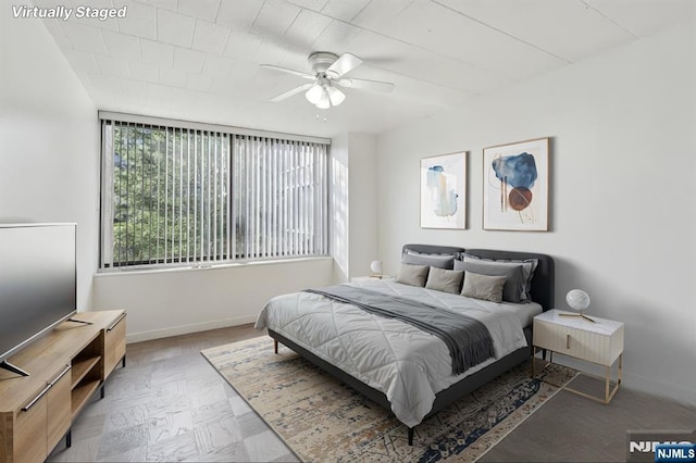 9060 Palisade Ave Unit 511, North Bergen, NJ 07047 - bedroom with baseboards and ceiling fan