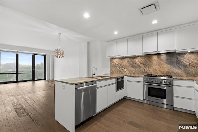 320 Adolphus Ave Unit 604, Cliffside Park, NJ 07010 - kitchen featuring appliances with stainless steel finishes, a peninsula, dark wood-style floors, white cabinets, and recessed lighting