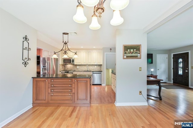 16 Murray Rd, Montvale, NJ 07645 - kitchen with stainless steel appliances, decorative backsplash, light wood-type flooring, pendant lighting, and a peninsula