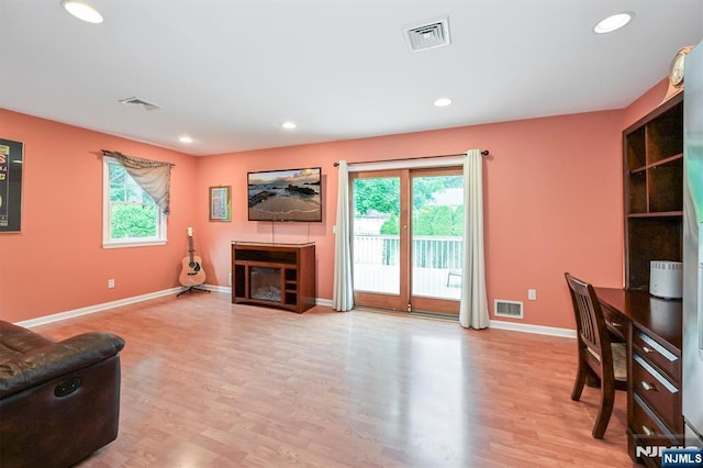 16 Murray Rd, Montvale, NJ 07645 - living area featuring healthy amount of natural light, a glass covered fireplace, wood finished floors, and recessed lighting