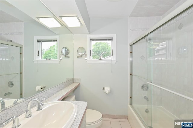 16 Murray Rd, Montvale, NJ 07645 - full bathroom featuring healthy amount of natural light, tile patterned flooring, vanity, and shower / bath combination with glass door